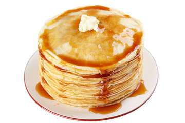A stack of thin pancakes with honey and butter