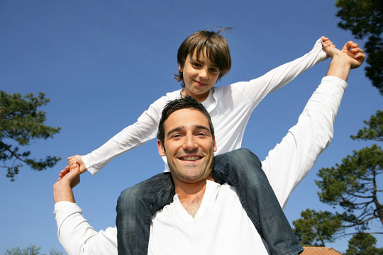 Man Carrying His Son On His Shoulders