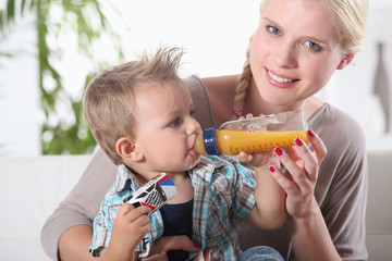 portrait of a woman feeding her son