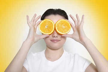 young woman with oranges as eyes