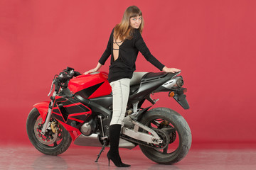 Naklejka na ściany i meble Young girl with bike, on red background