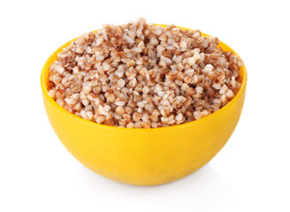 Boiled buckwheat in a yellow bowl isolated on white