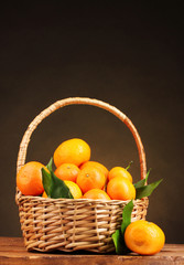 tangerines with leaves in a beautiful basket