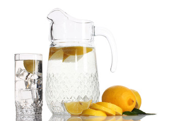Fototapeta premium pitcher and glass of lemonade and lemon isolated on white