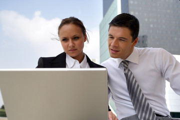 Businesspeople working on a project together outside