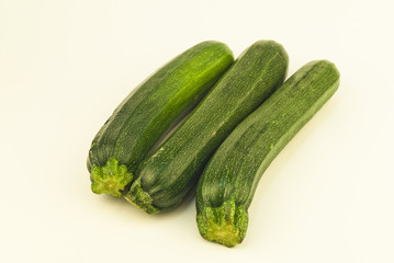 Three zucchini, Courgettes, on white background