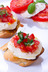 Fresh and tasty bruschetta on white plate