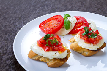 Fresh and tasty bruschetta on white plate