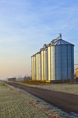 silos in the middle of a field in wintertime © travelview