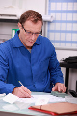 Man using calculator to verify accounts