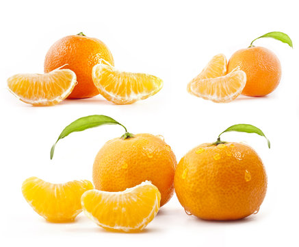Tangerines with water drops and green leaves