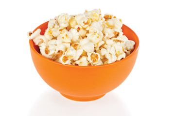 Popcorn in a orange bowl on a white background