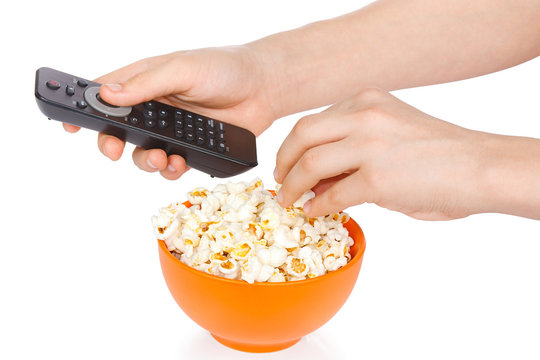 Hands a teenager with popcorn and remote control