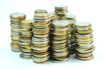 Coins in piles on white background