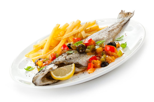 Fish dish - roast trout and vegetables on white background