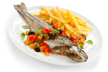 Fish dish - roast trout and vegetables on white background