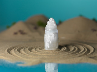 Fototapeta na wymiar white crystal in miniature sea shore landscape