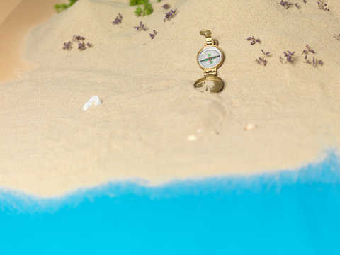 golden compass in sand, miniature landscape