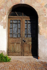 Fototapeta na wymiar Old door made of wood, iron and glass