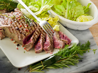 sliced steak with green salad