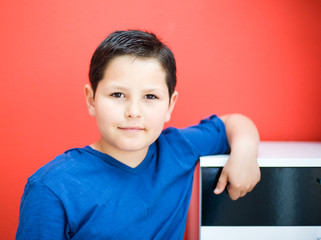 Portrait of a boy on a red background