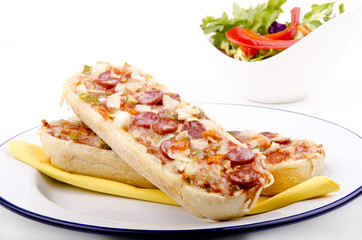 salami baguette with onion and fresh salad in a bowl