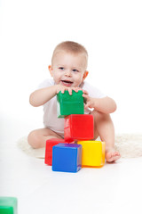 little boy plays bright toys