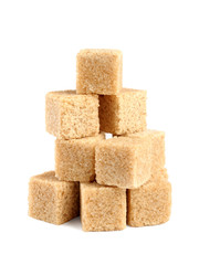 Pile of cane sugar cubes isolated on white background