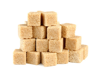 Pile of cane sugar cubes isolated on white background