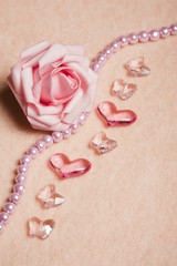 Wedding background with rose and  heart-shaped beads