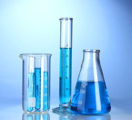 Laboratory glassware with blue liquid with reflection