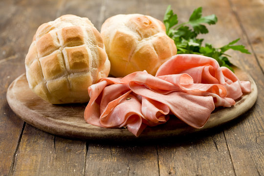 Mortadella with Bread on Chopping board