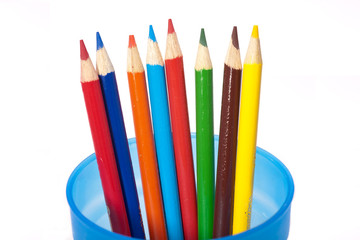 Coloring pencils spread in blue cup