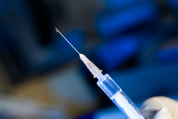 Syringe ready for injection with a drop of liquid