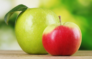 Two ripe apples on table outdoors