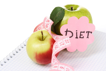 Planning of a diet. Notebook, pencil and fresh apples isolated