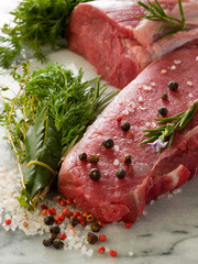 raw porterhouse and tenderloin with mixed herbs juniper berry