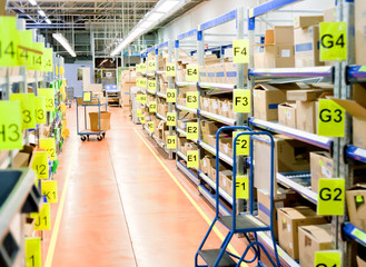 stands with carton boxes in storage warehouse