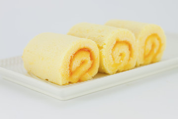 Orange Rolls cake on white plate