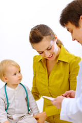 Pediatric doctor explaining something to mother with baby