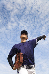 baseball pitcher with cloud backgroung