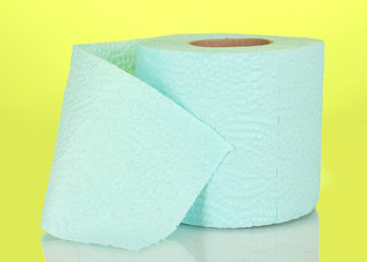 blue roll of toilet paper on yellow background