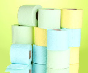 bright rolls of toilet paper on green background