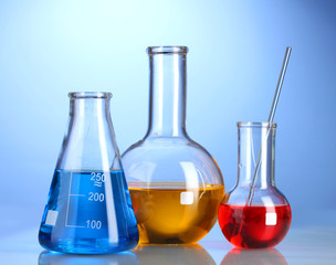 Three flasks with color liquid with reflection