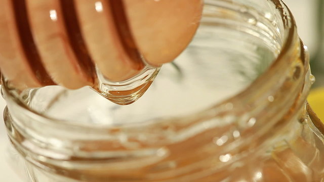 Breakfast - Honey dripping on glass container