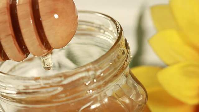 Breakfast - Honey dripping on glass container