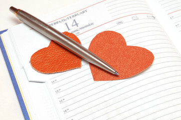 Calendar, heart and a pen