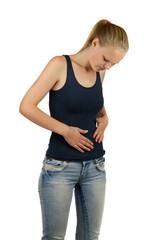 Young woman is holding her belly in pain, on white background