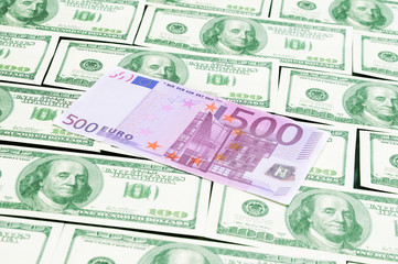 Fototapeta na wymiar Euro banknote lying on the dollars background