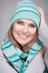 smiling woman with scarf and hat